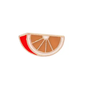 Detailed view of orange slice enamel brooch with gold-tone plating and vibrant colors