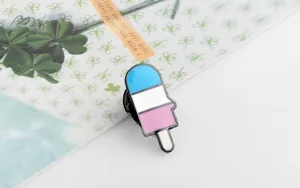 Detailed view of a tricolor popsicle enamel pin with sky blue, white, and pink layers