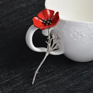 Elegant red poppy flower enamel brooch with silver stem on a minimalist background
