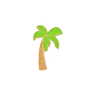 Tropical palm tree enamel brooch with green leaves and golden trim on white background