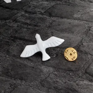 Minimalist white enamel flying bird brooch with gold-plated butterfly clutch on stone