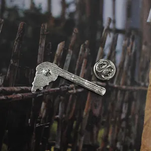 Detail view of the silver metal pin back and butterfly clutch closure for enamel pins