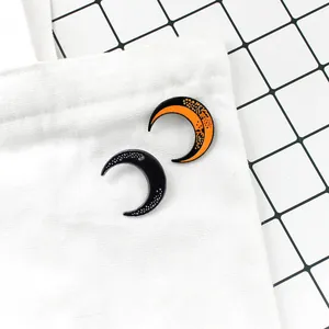 Fashionable crescent moon enamel pins in orange and black for denim jackets and backpacks