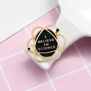 Science theme enamel pin with I Believe in Science text and golden atomic orbits