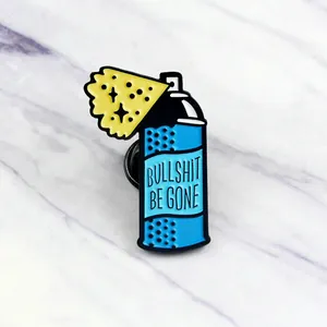 Blue spray can enamel pin featuring Bullshit Be Gone slogan with black butterfly clutch