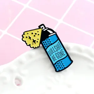 Detailed close-up of a blue enamel pin with humorous Bullshit Be Gone slogan text