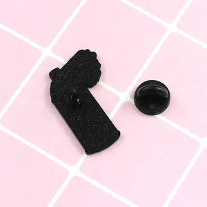 Macro shot of matte black metal brooch back with needle pin and rubber clutch detail