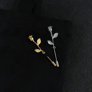Detalle de broches de rosa esmaltados en oro y plata con elegante grabado floral