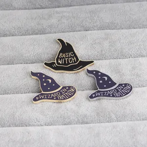 Detail of wizard hat enamel pins featuring Basic Witch and Wizard in Training text