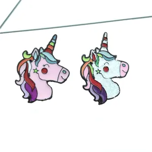 Set of two colorful cartoon unicorn enamel pins with glitter details and rainbow horns