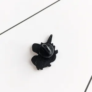 Black enamel unicorn brooch back view with rubber clutch fastener on white background
