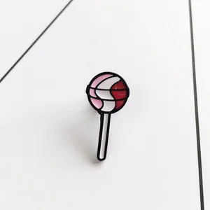 Chic lollipop enamel pin brooch with pink and red swirls on minimalist background