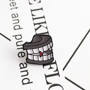 Cartoon tooth enamel pin with red heart detail on white card background