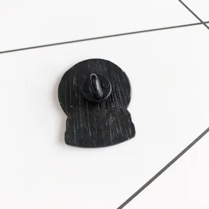 Black matte cartoon crystal ball brooch back view with metal pin and butterfly clasp