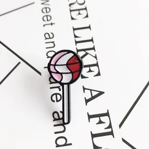 Lollipop enamel pin badge with colorful spiral patterns on a white display card