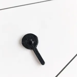 Minimalist black lollipop-shaped metal enamel brooch pin with a sleek matte finish