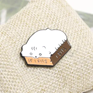 Detail of white cat enamel pin with If I Fits I Sits quote on orange box