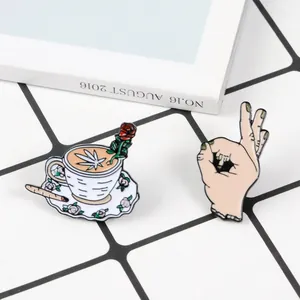 Punk style enamel pins set featuring a coffee cup with rose and a provocative OK hand gesture