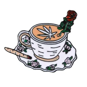 Punk style coffee cup enamel pin with red rose and green leaf design on white background