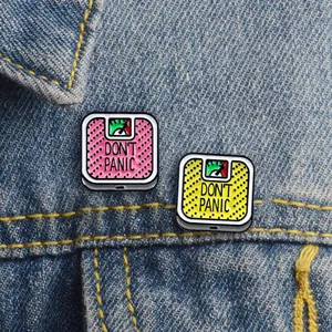 Funny Don't Panic scale enamel pin badge on denim jacket pocket for fashion styling