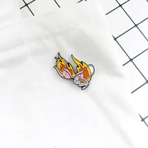 Close-up of 'IT'S LIT' enamel pin featuring a pink bikini burning in yellow flames