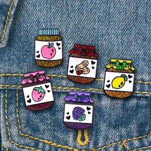 5-piece colorful enamel fruit jam jar badges pinned on a blue denim jacket pocket