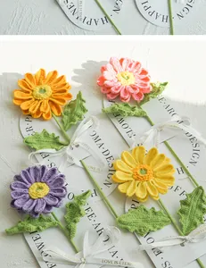 Handcrafted crochet gerbera daisy bouquet with colorful knit petals and decorative ribbon