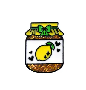 Detailed view of creative lemon jam jar enamel pin with yellow bow and glitter finish