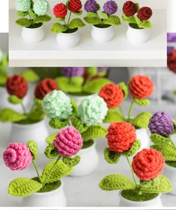 Macro detail of hand-knitted mini potted plants showing soft yarn textures and white ceramic pots