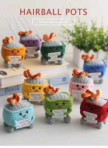 Detailed view of colorful knitted emotional support dumpster fire dolls with gift cards