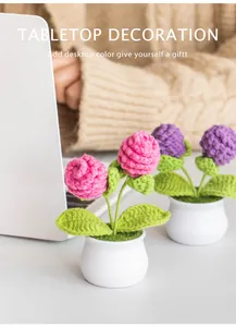 Detailed view of handmade crochet potted flowers with white ceramic base for table decor