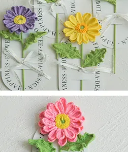 Detail of hand-knitted daisy bouquet with Love Is Eternal ribbon and elegant card packaging