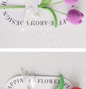 Close-up of hand-knitted purple tulip with green leaves and Love Is Eternal ribbon