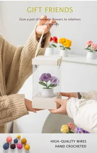 Hand-crocheted purple carnation in gift box being given as a handmade present