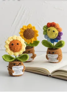 Detail of crochet sunflower pots with emotional support cards on a wooden desk