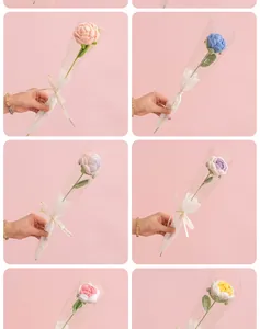 Detail showing various colors of handmade crochet roses with elegant gift wrap