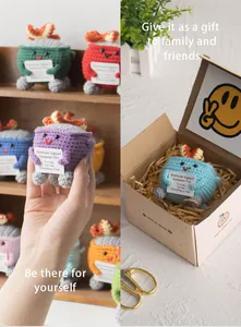 Detailed view of handmade crochet trash bin dolls in various colors with gift box