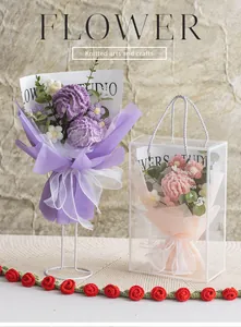 Detail of handmade crochet flower gift box featuring purple carnations and daisies