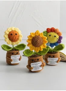 Detailed view of three handmade crochet sunflower potted plants with supportive gift cards