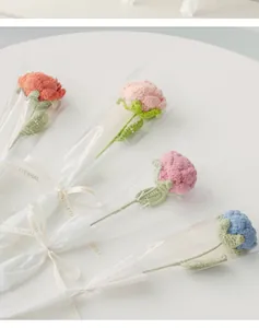 Detail of handmade crochet roses in elegant gift bags with Love Is Eternal gold ribbon