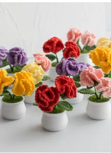 Detailed view of handmade crochet carnation potted plants in various vibrant colors