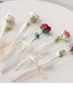 Handmade knitted roses in individual gift bags with elegant ribbons for special occasions