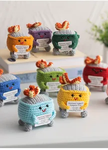 Detailed view of colorful crochet emotional support dumpster fires with positive quote cards