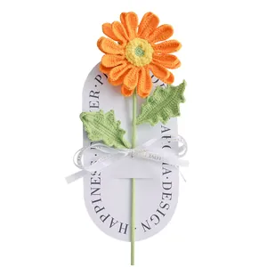 Handmade knitted orange daisy flower bouquet with white gift card and ribbon decor
