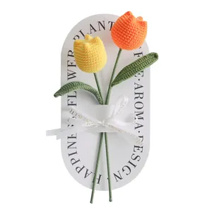 Handmade crochet tulip flower bouquet with yellow and orange petals on a white gift card