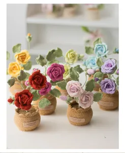 Close-up of handmade crochet rose potted plants with handmade limited edition label
