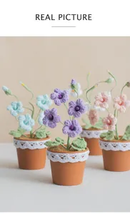 Close-up of handmade crochet freesia flowers with lace-decorated pots in various colors