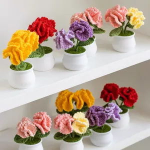 Handmade knitted carnation potted plant with colorful crochet flowers on white shelves
