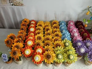Detail of handcrafted crochet sunflower potted plants in various vibrant yarn colors