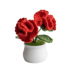 Handmade crochet red carnation flower in ceramic pot for festive home decoration